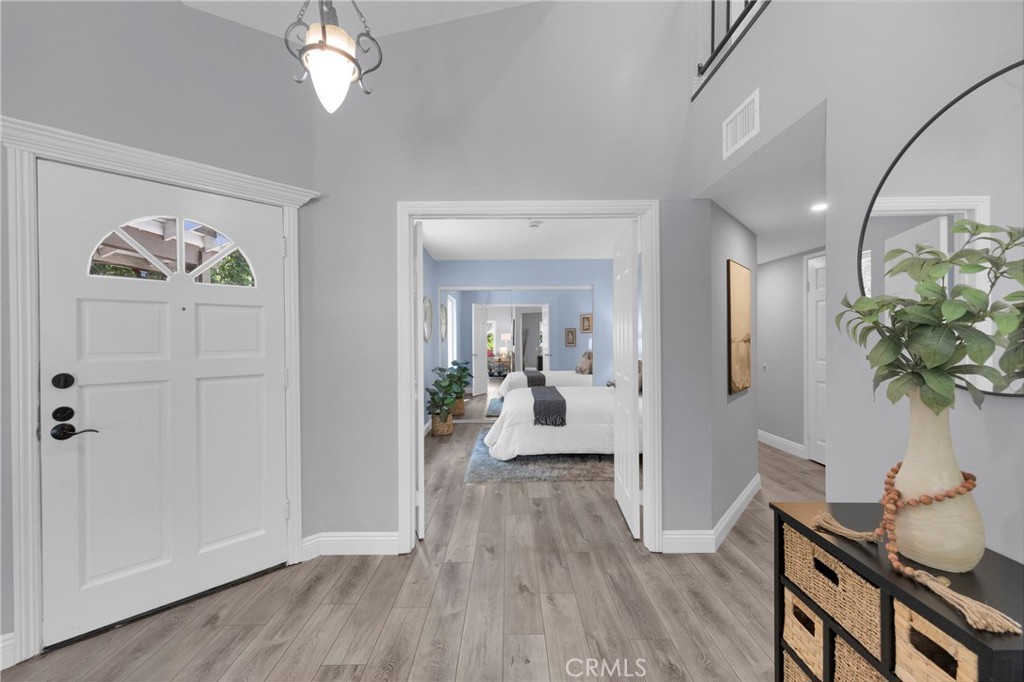 Dining area at 3675 Cypress Ln with a large window framing the backyard and hillside light filling the room